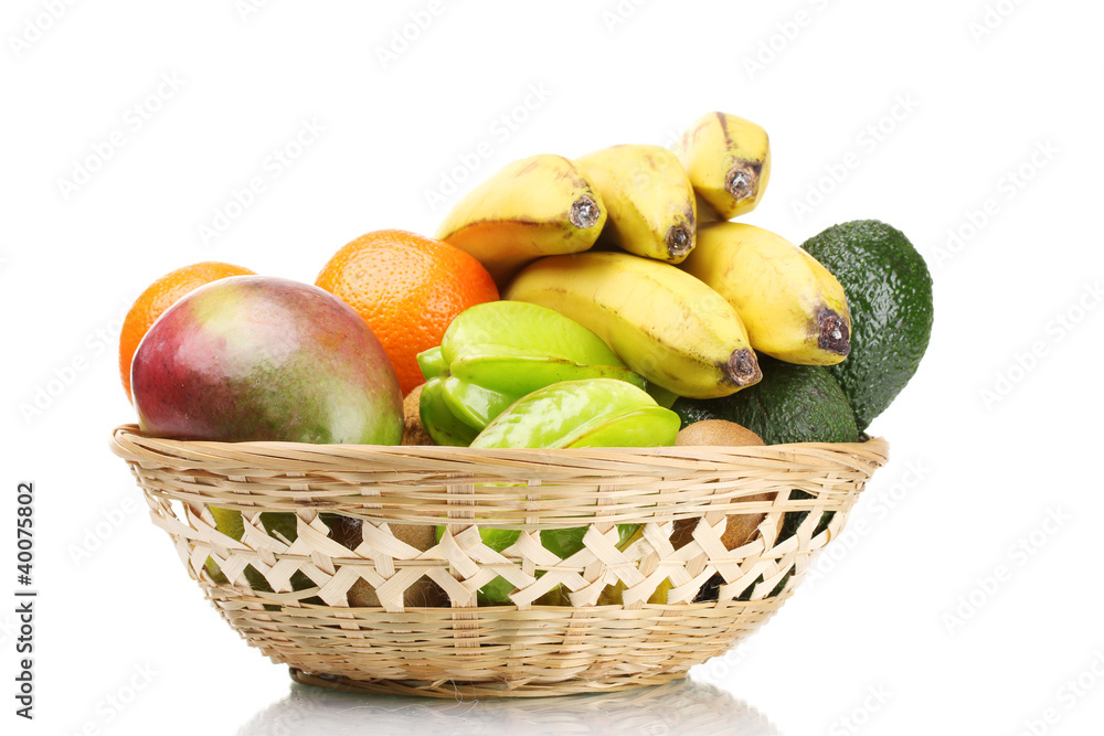 Assortment of exotic fruits in basket isolated on white