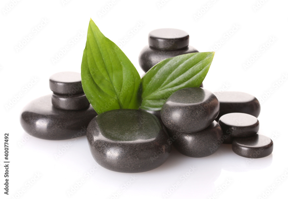 Spa stones and green leaves isolated on white Spa stones and green leaves isolated on white