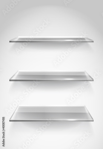 Three empty advertising glass shelves on the wall