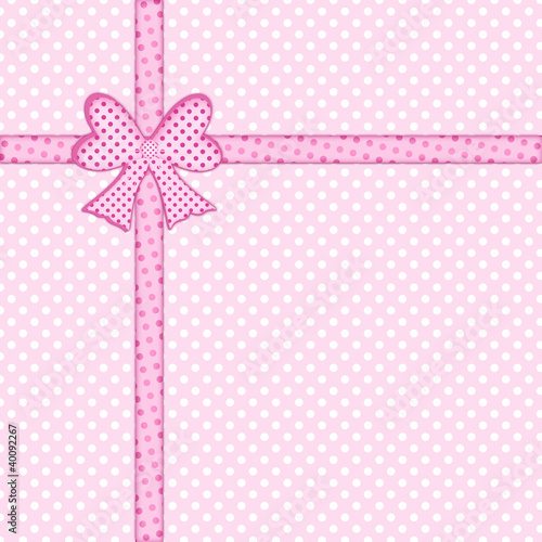 Gift bow and ribbon on pink polka dot background
