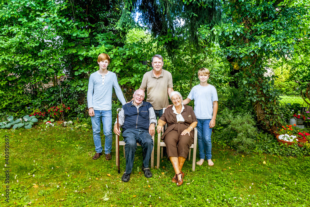 extended family group posing in the garden with grandparents