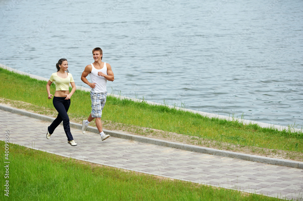 Young man and woman jogging outdoors Young man and woman jogging outdoors