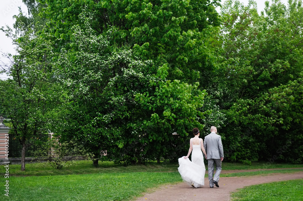 Bride and groom walking together Bride and groom walking together
