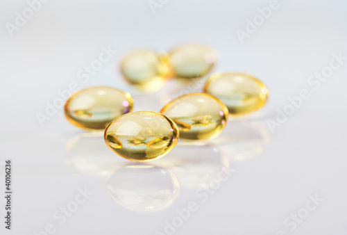 Pills (capsules) of cod-liver oil, macro view on white