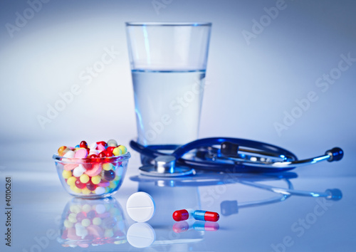 Pills and tablets macro still life on white blue, medical therap photo