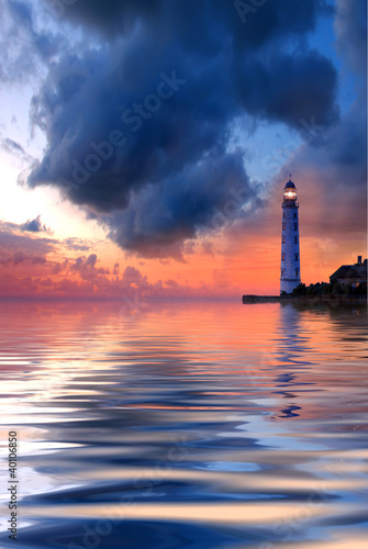 Beautiful nightly seascape with lighthouse and moody sky