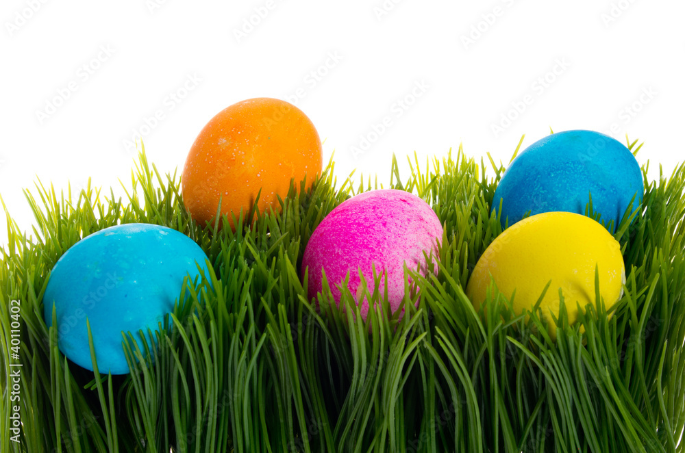 Bright colorful dyed eggs in grass