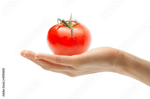 Female hand with a tomato