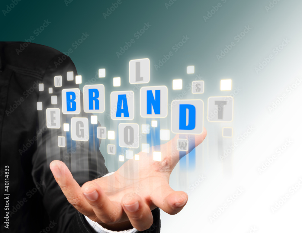 Businessman hand holding with blue brand alphabet Businessman hand holding with blue brand alphabet