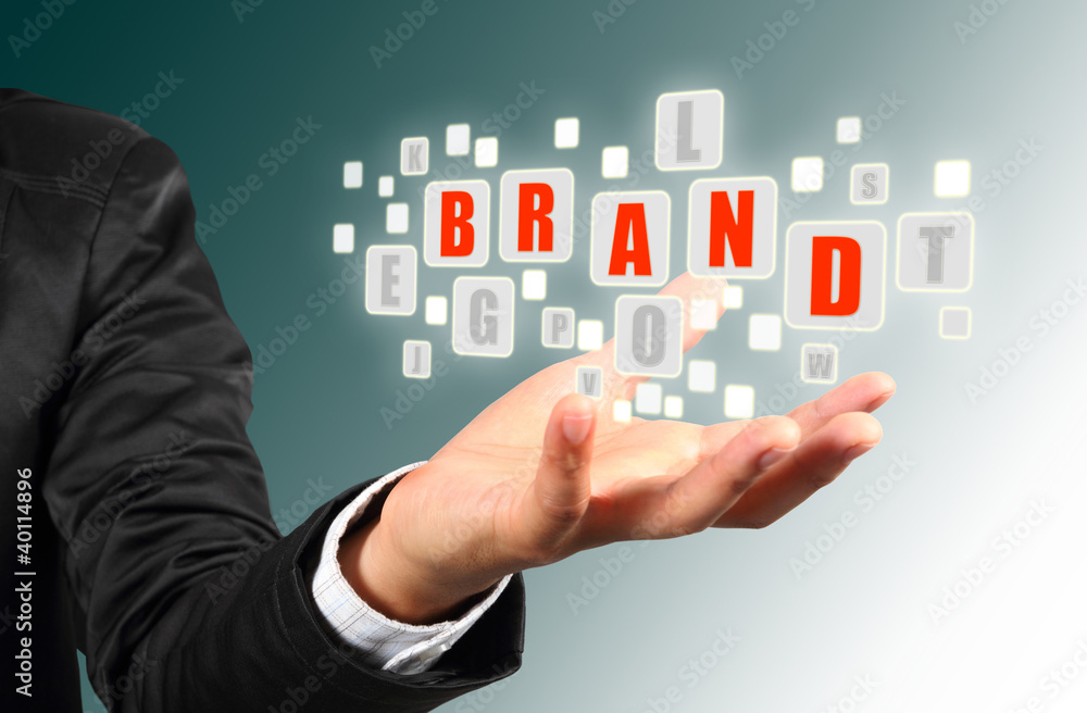 Businessman hand holding with blue brand alphabet Businessman hand holding with blue brand alphabet