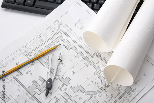 Compasses, a pencil and a ruler over a draft