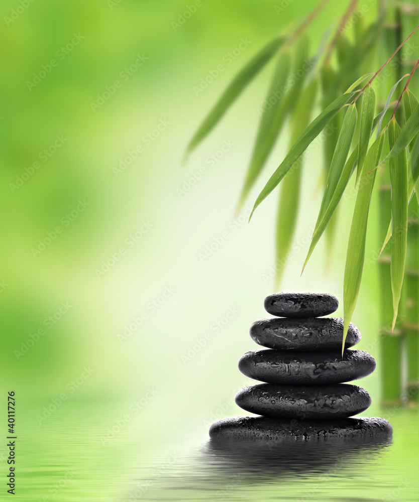 Tranquil zen design with stacked massage stones and bamboo Tranquil zen design with stacked massage stones and bamboo
