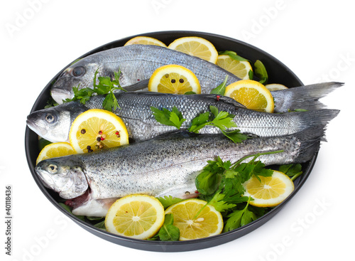 Fresh fishes with lemon, parsley and pepper