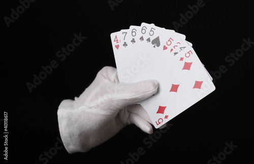 Cards in hand isolated on black