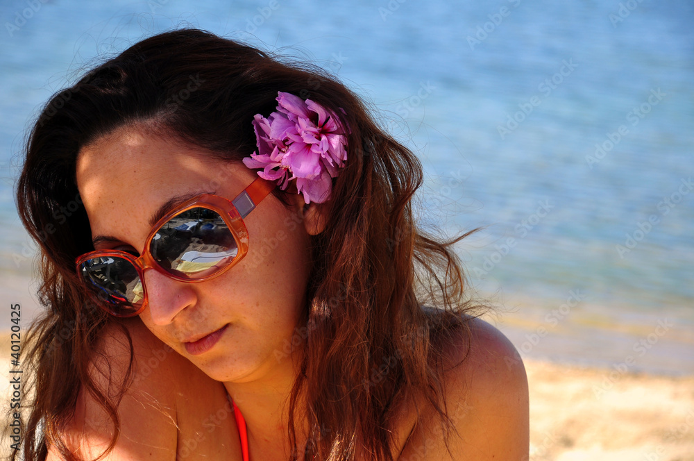 woman at beach with flower on her hair