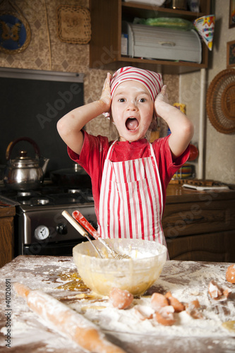 little chef in the kitchen wearing an apron and headscarf