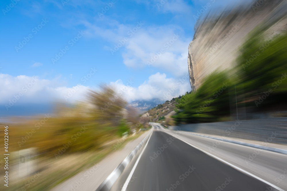 Winding road in mountainous terrain at high speed