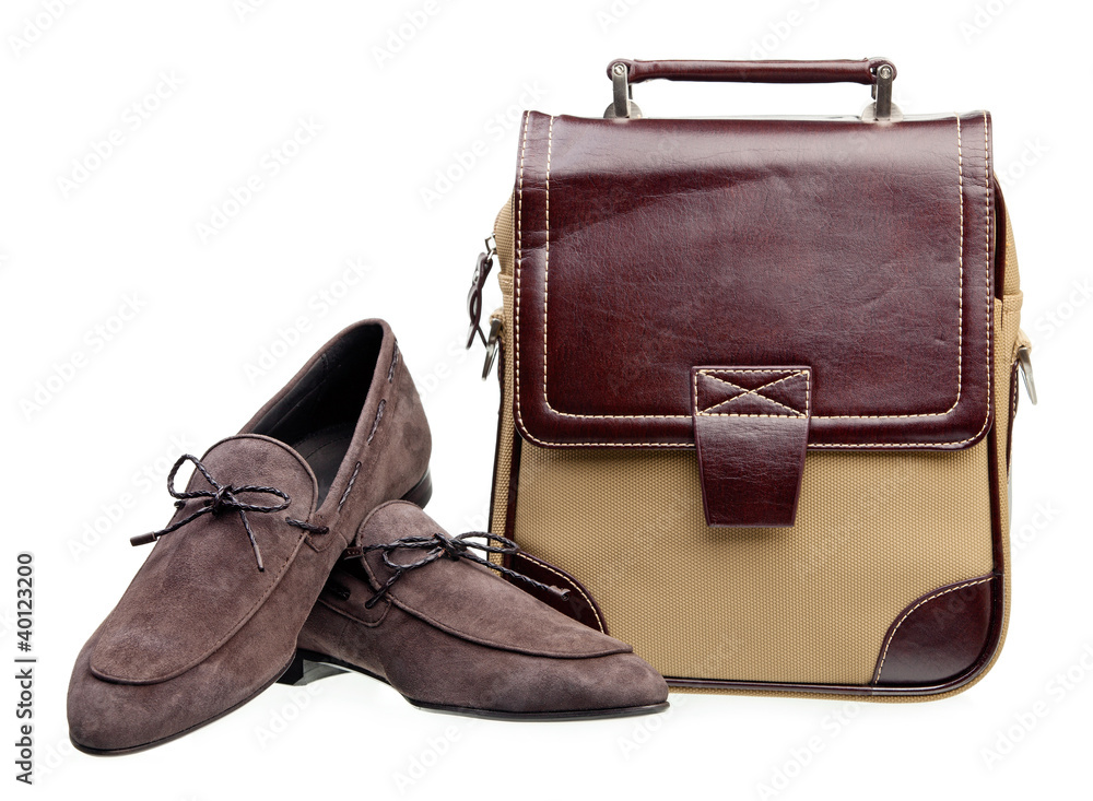 Naklejka premium Pair of brown men loafers and messenger bag over white