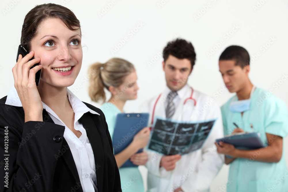 businesswoman in a hospital talking on her cell businesswoman in a hospital talking on her cell