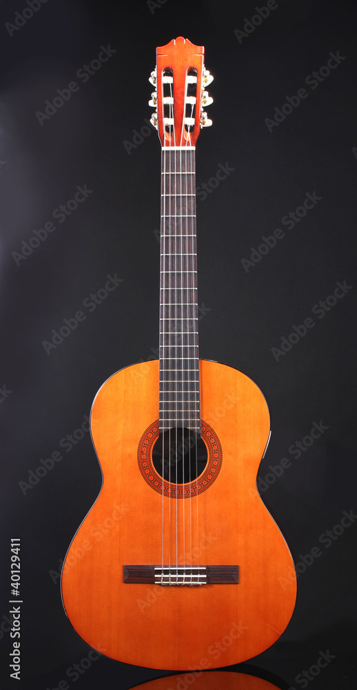 Naklejka premium retro guitar on black background