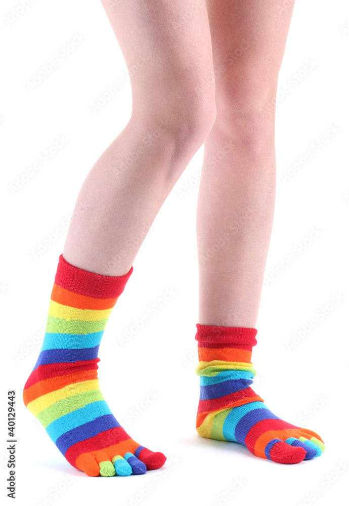 female legs in colorful striped socks isolated on white female legs in colorful striped socks isolated on white