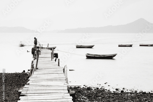 Photography Lonely pier along the coast, low saturation image.