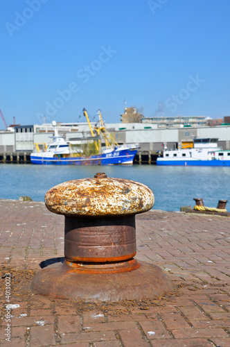 An old bollard on the wharf in a Dutch fishing port.