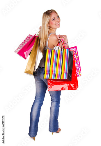 Beautiful blond girl with shopping bags on white