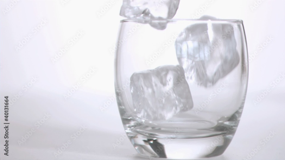 Ice cubes in super slow motion falling in a tumbler Ice cubes in super slow motion falling in a tumbler