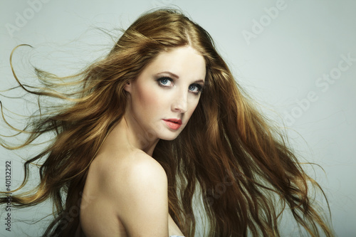 Portrait of young beautiful woman with long flowing hair