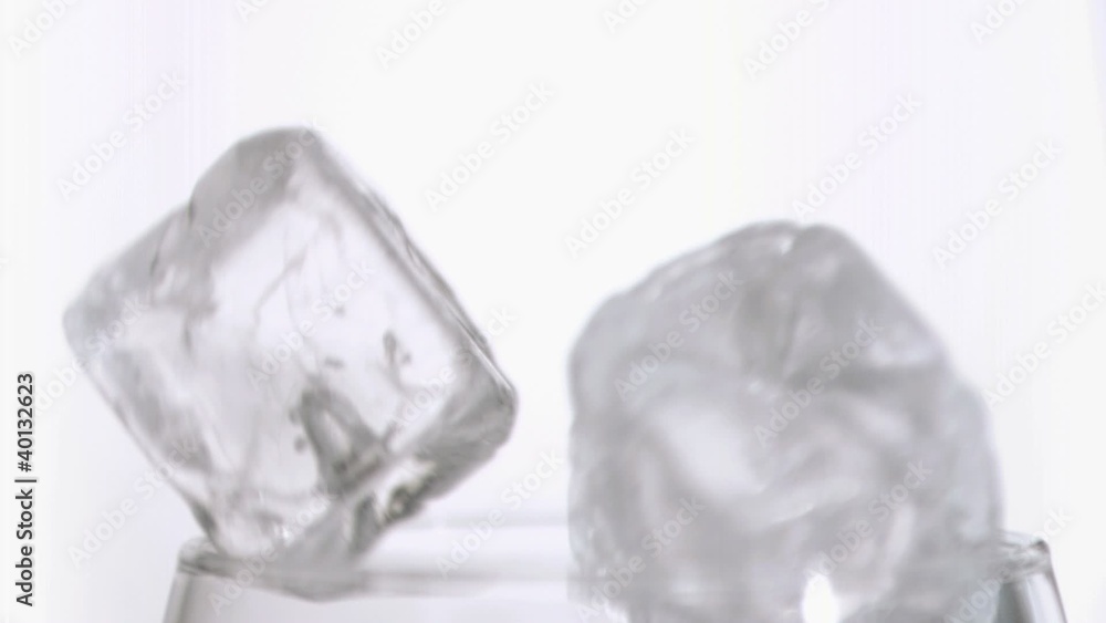 Ice cubes in super slow motion falling together Ice cubes in super slow motion falling together