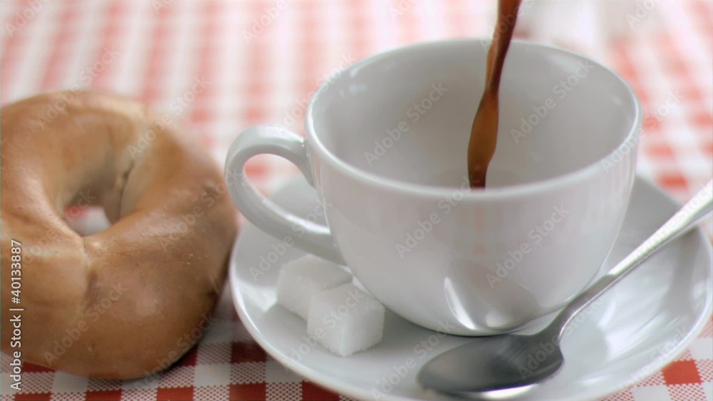 Coffee filling a cup in super slow motion Coffee filling a cup in super slow motion