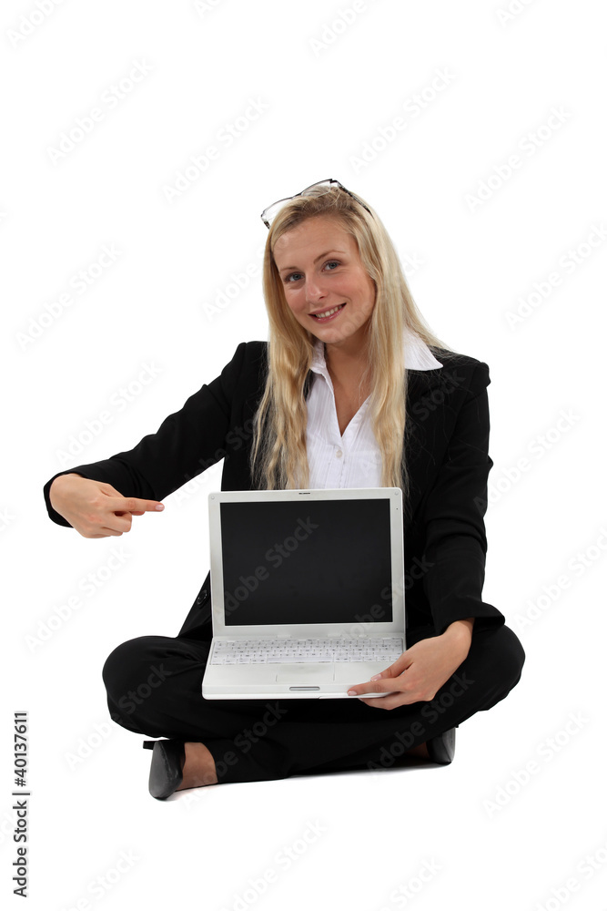Blond businesswoman sat pointing at laptop Blond businesswoman sat pointing at laptop