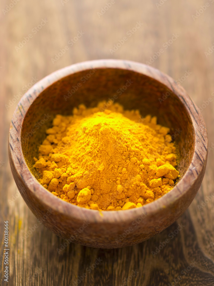 close up of a bowl of grounded turmeric close up of a bowl of grounded turmeric