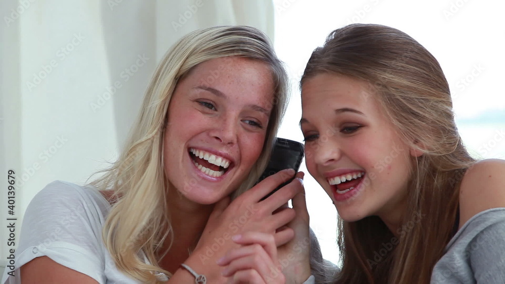 Happy woman using a cellphone together Happy woman using a cellphone together