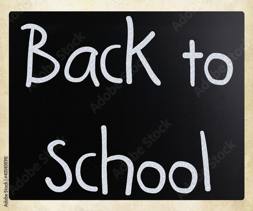 "Back to school" handwritten with white chalk on a blackboard