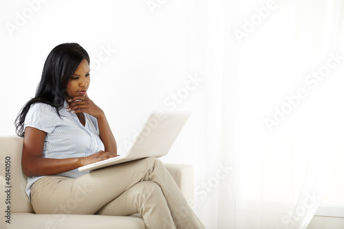 Cute woman with laptop on sofa © pablocalvog