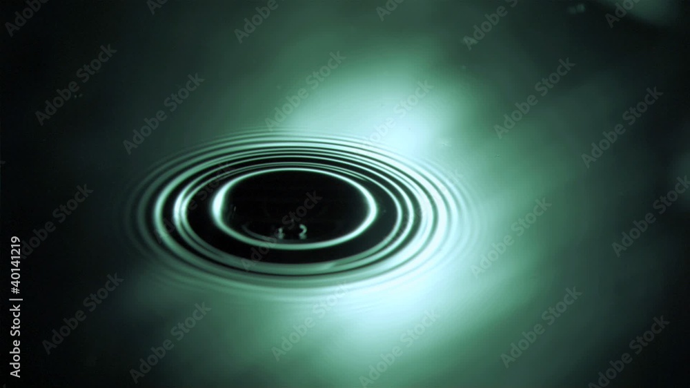 Drop falling in super slow motion on a water surface Drop falling in super slow motion on a water surface