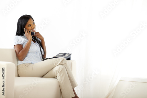 Relaxed pretty young lady speaking on phone