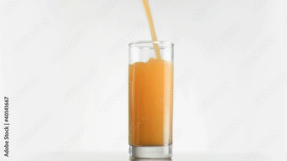 Mango juice filling in super slow motion a glass Mango juice filling in super slow motion a glass