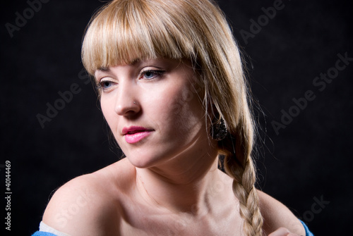 The beautiful girl with a plait against