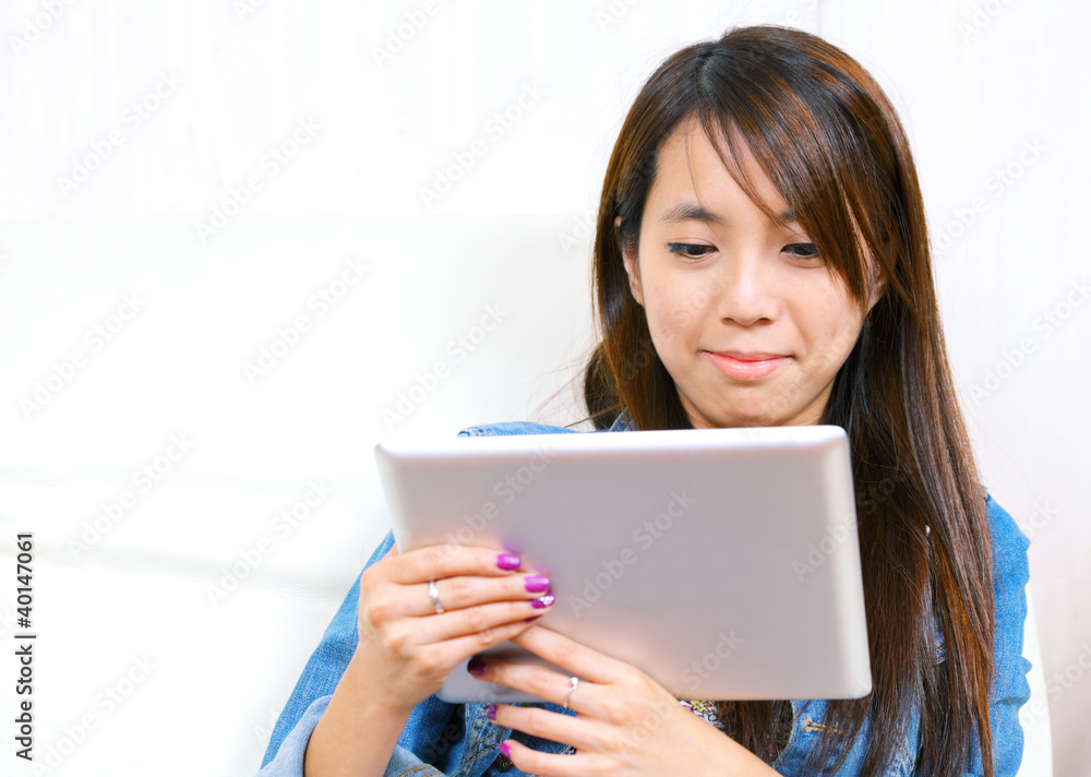 young asian woman using tablet computer young asian woman using tablet computer