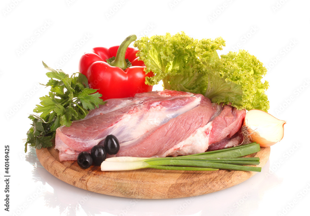 Raw meat and vegetables on a wooden board isolated on whitе
