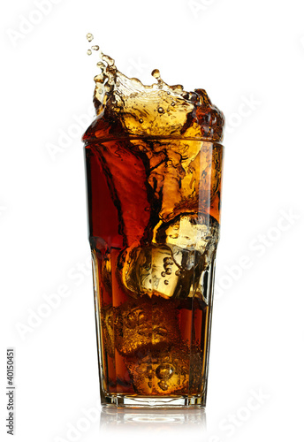 Splashing cola in glass. Isolated on white background photo