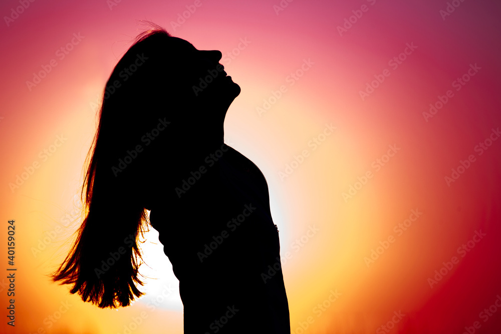 Woman relaxing at sunset