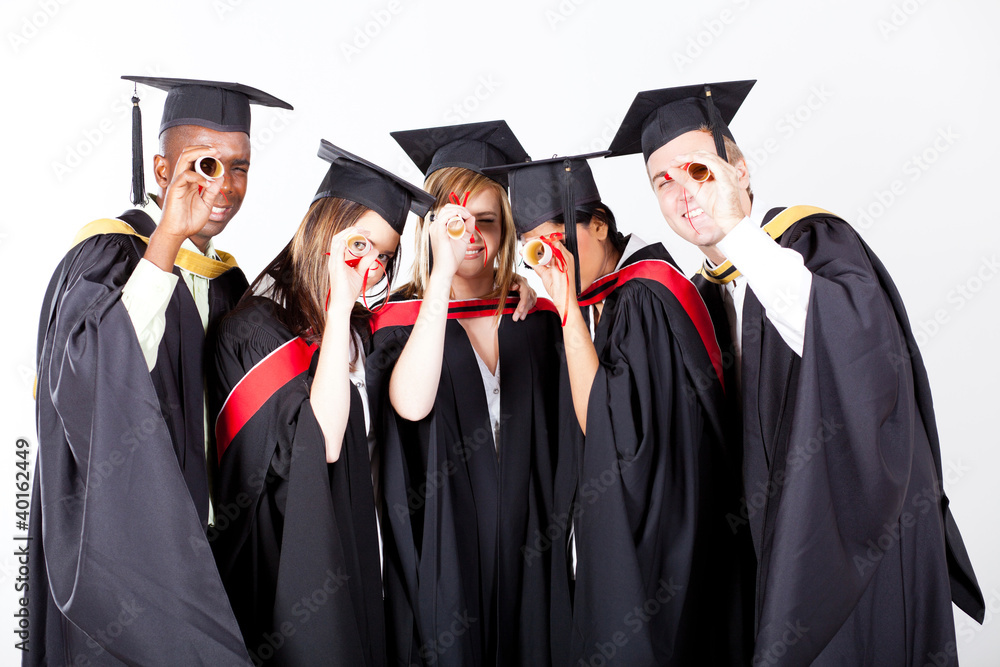 group of graduates looking through their diploma group of graduates looking through their diploma