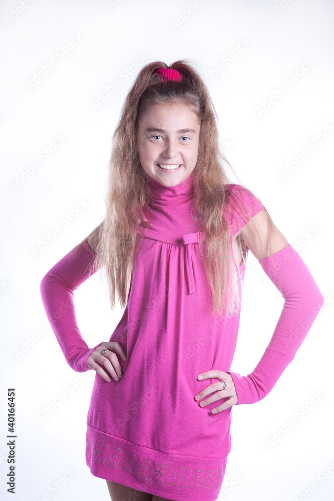 teen girl in a pink dress posing in studio