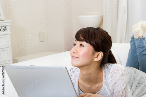 Beautiful asian woman using a laptop computer