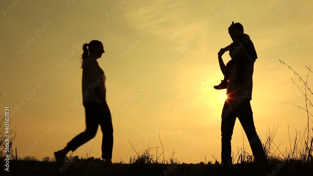 sillouetted family walk at sunset orange sky sillouetted family walk at sunset orange sky