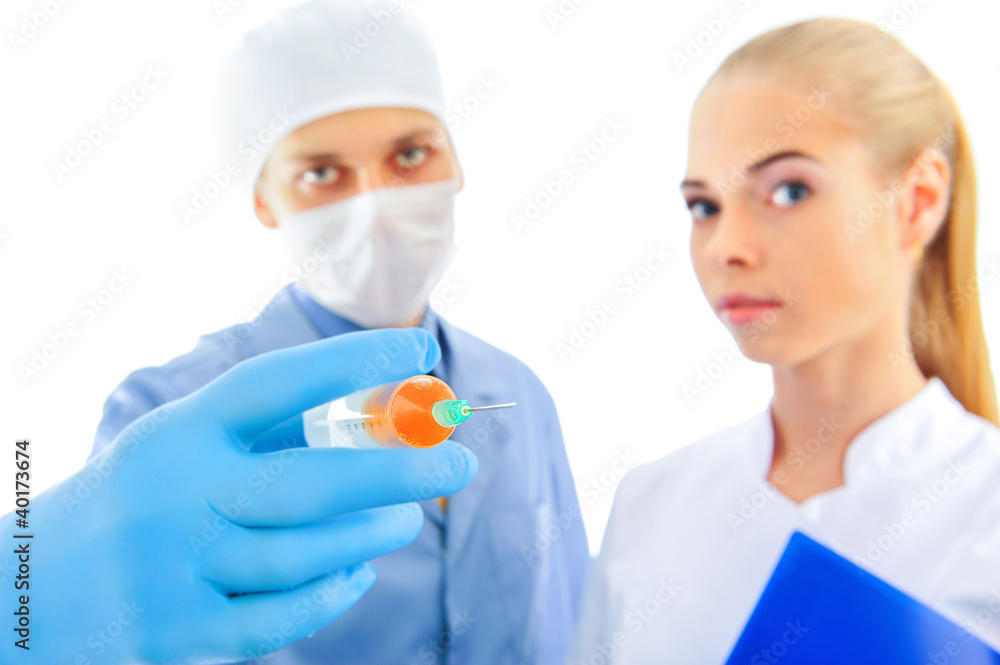 Portrait of Smiling doctor with his colleague showing syringe Portrait of Smiling doctor with his colleague showing syringe